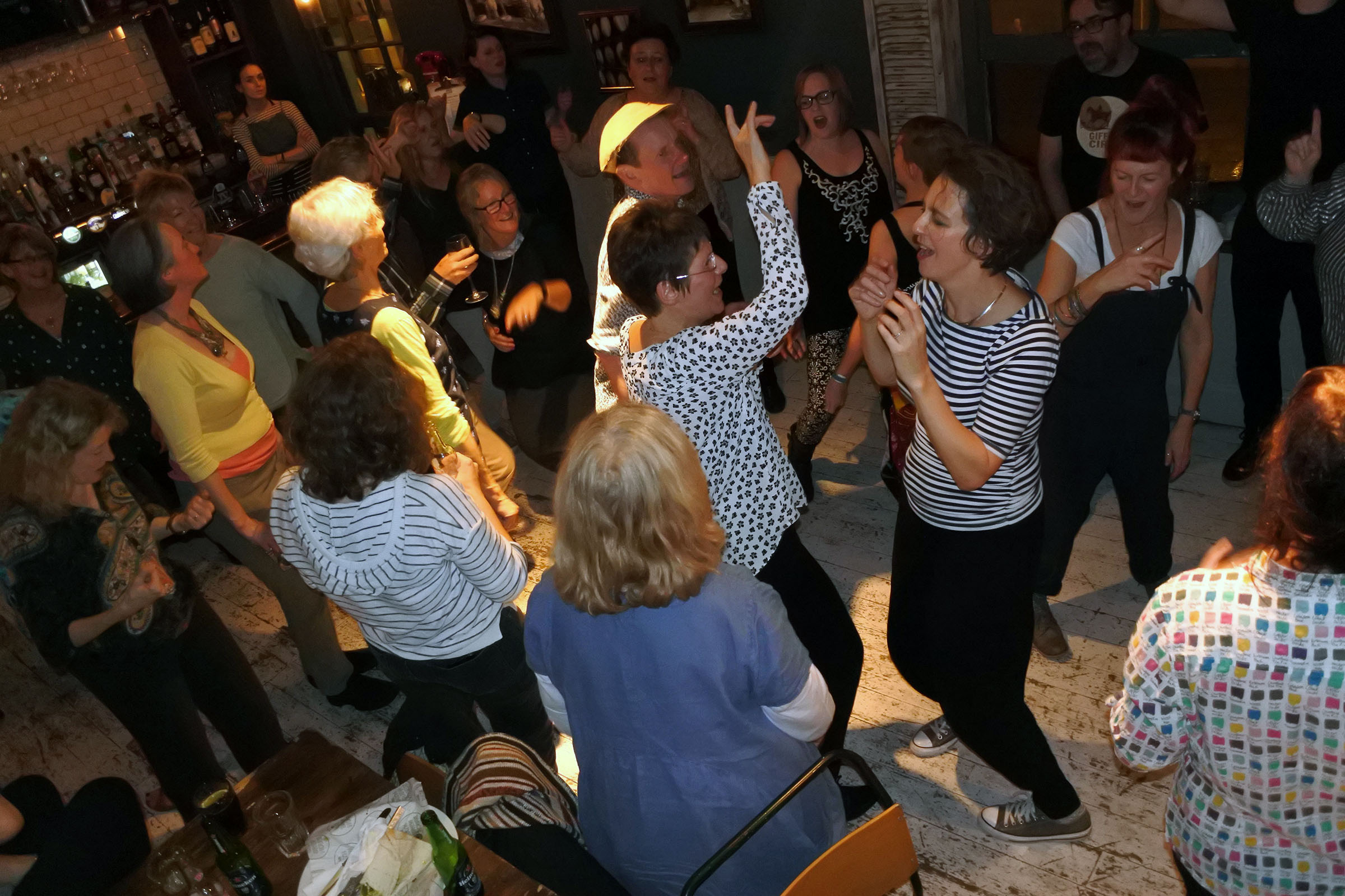 People singing and dancing in the pub