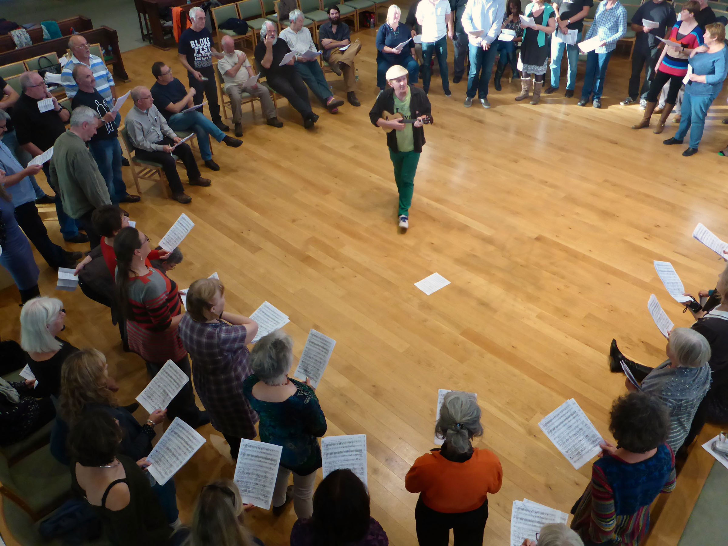 Director playing uke teaching choir