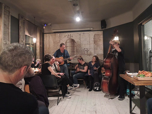 Singers and guitarist in pub
